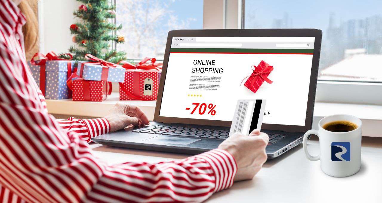 Person shopping online with Christmas decorations in the background