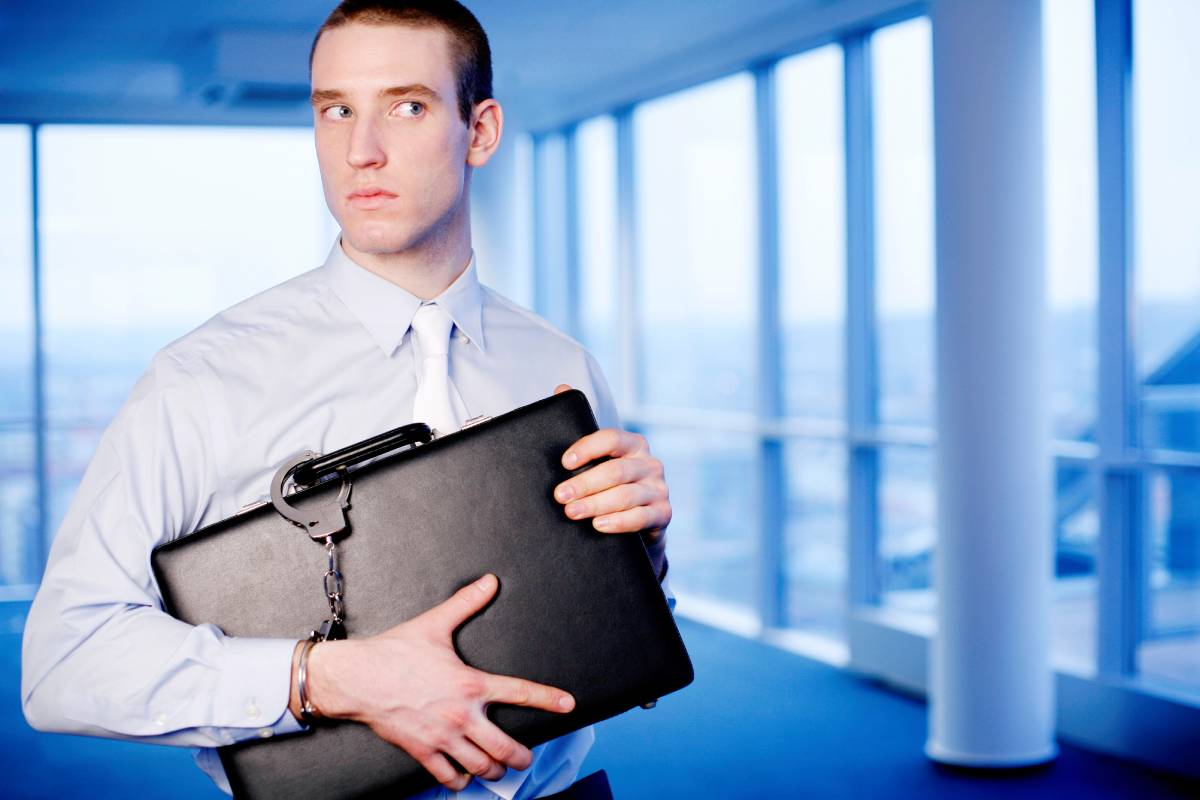 Businessman with a briefcase handcuffed to his wrist
