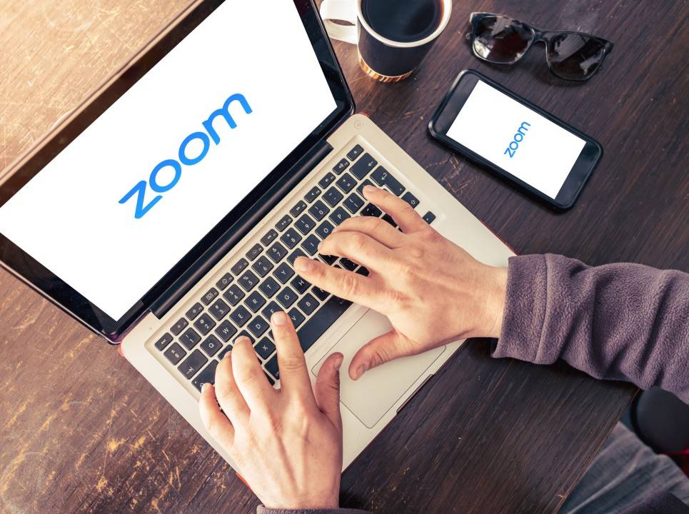 Person using Zoom on a laptop